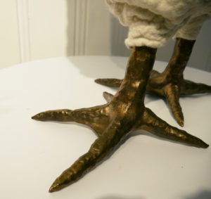 The bronze foot of a chicken footstool