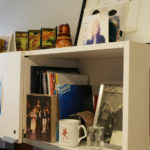 A shelf in Devon's office, lined with pictures of his past performances.