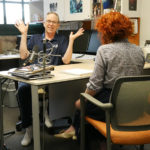 Devon Carney chats with host Betsy Blodgett from his office