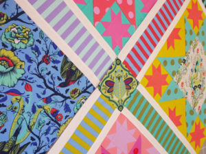 A quilt work-in-progress featuring Tula Pink's All Stars fabric collection.