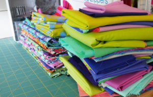 Stacks of fabric wait to be used in Tula Pink's studio.