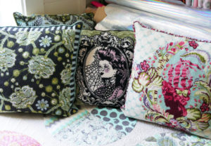 Three of Tula Pink's needlepoint pillows, which were once available as kits.