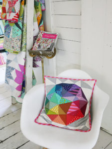 A chair holds a Tula Pink pillow pattern in a corner of her office.