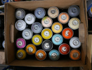 A rainbow of spray paint in Phil Shafer's studio.