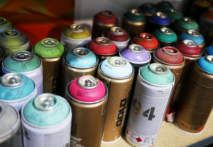 The tools of the trade: a shelf of spray paint in Phil Shafer's studio.