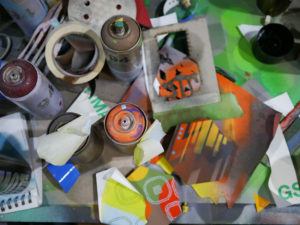 Work table full of spray paint, hexagons and stencils in Phil Shafer's studio.