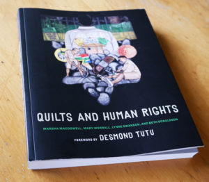 The cover of the book Quilts and Human Rights, which features an article on Nedra.