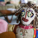 Detail of the beaded face of one of Nedra's handmade dolls.