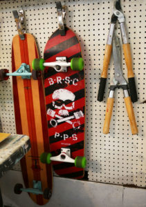 Skateboards hang next to tools in Seth Smith's studio.