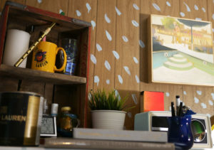 Books and trinkets fill cubbies in Seth Smith's studio.
