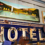 Paintings depicting scenes from Hollywood to Lawrence, KS hang on artist Seth Smith's wall.