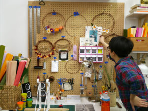 Grace D. Chin straightens the supplies in her studio.
