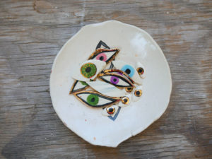 A bowl of ceramic evil eyes from Sweet Destructor.