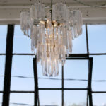 The chandelier that Evie turns on to symbolize that it is time to work.