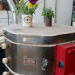 An evil eye cup acts as a vase resting on top of the kiln in the Sweet Destructor studio.