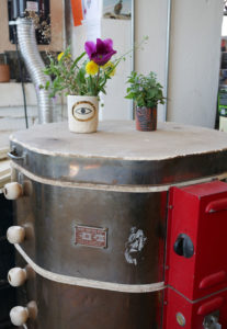 An evil eye cup acts as a vase resting on top of the kiln in the Sweet Destructor studio.