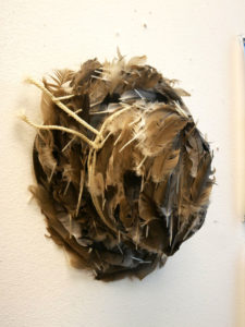 A piece of feathered art hangs on Jillian's wall.