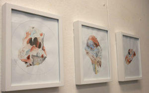Jillian's paintings hang on the wall of her studio.