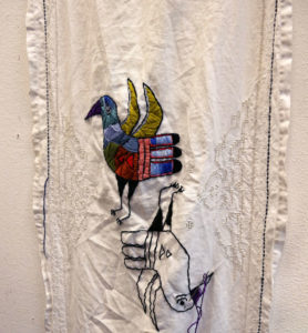 A piece of Jillian's embroidery on a vintage table runner.
