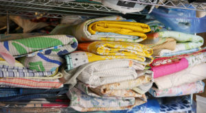 Piles of quilts sit on shelves in Luke's studio.