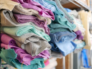 Piles of fabric from Luke's fabric line Dapper for Moda Fabrics.