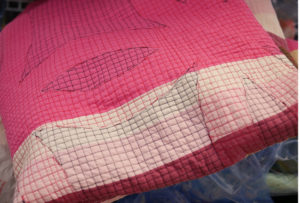 Geometric quilting on a quilt in Luke's studio.
