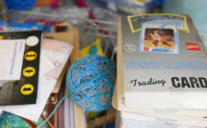 Sports trading cards share shelf space with quilts in Luke's studio.