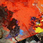 A paint palette is awash in bold, bright colors, which are currently being used in a new work of Glyneisha's.