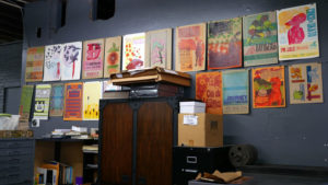 Two Tone Press designs displayed in the studio office.