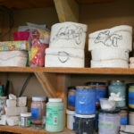 Shelves stacked with glaze in Momoko's studio.