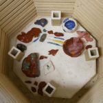 Ceramic pieces from Momoko's community class are fired in her kiln room.