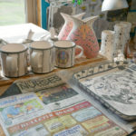 Mugs and moth vases await the next firing.