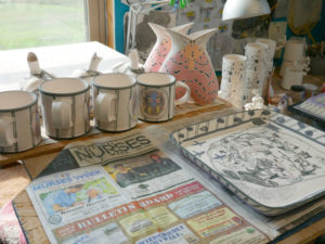 Mugs and moth vases await the next firing.